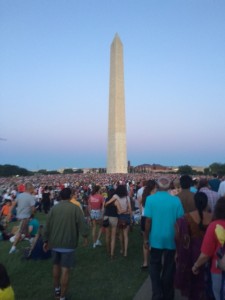 People gathering in anticipation of the firework show over the reflecting pool.