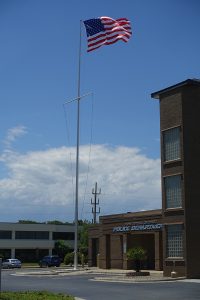 Flagpole with U.S. flag next to public safety building